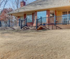 Beautiful custom wooden deck with railing and stairs, perfect for outdoor gatherings in a residential backyard setting. Custom wooden deck with railing and stairs in a residential backyard.