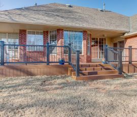 Beautiful custom wooden deck with stairs and railing, perfect for outdoor gatherings and relaxation. Custom wooden deck with stairs and railing in backyard.