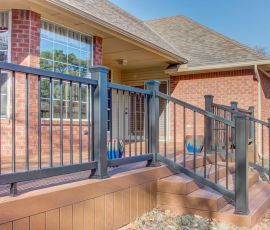 Beautiful custom deck featuring black metal railing and wooden stairs, perfect for outdoor gatherings and relaxation. Custom outdoor deck with black metal railing and wooden stairs for enhanced backyard space.