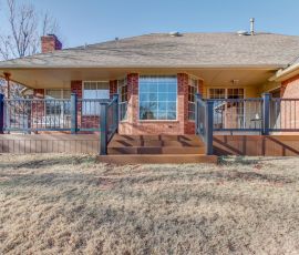 Beautiful custom backyard deck with stairs and railing, perfect for outdoor gatherings and enjoying the view. Custom backyard deck with stairs and railing in a residential yard.