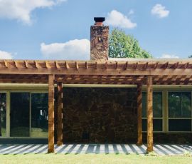 Elegant wooden deck with pergola enhances outdoor living space, perfect for gatherings and enjoying nature. Beautiful custom wooden deck extension with pergola for outdoor entertainment and relaxation.