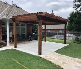 Beautiful backyard with custom wooden pergola providing shade and enhancing outdoor living space. Wooden patio cover with pergola design for outdoor shade and aesthetic appeal.